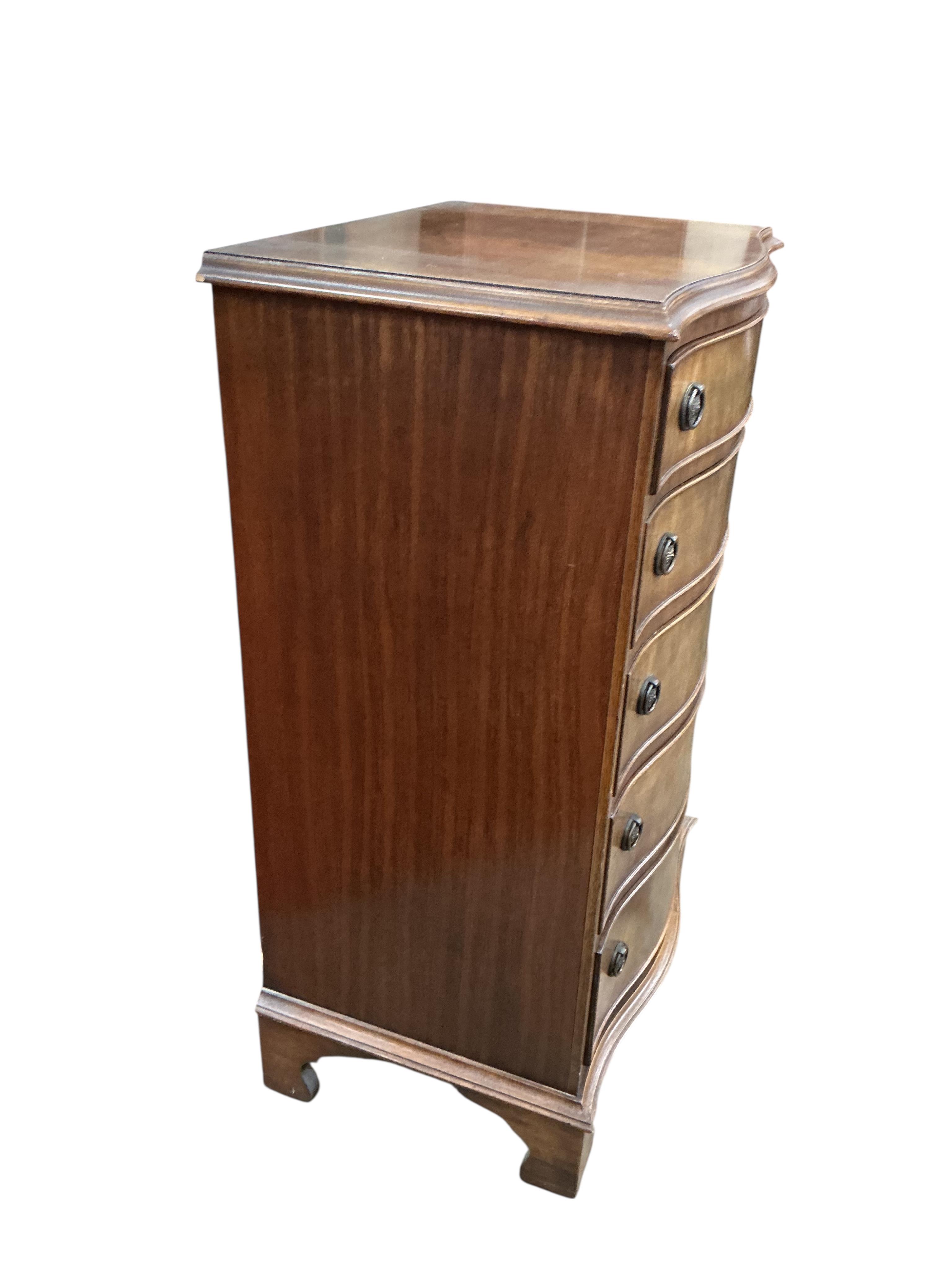 A reproduction George III style mahogany serpentine chest of five drawers, width 54cm, depth 41cm, height 92cm